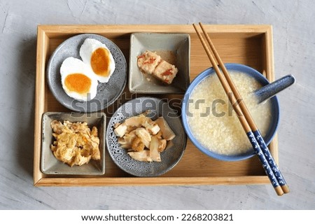 Typical Chinese breakfast, lunch meal. Millet Porridge with Fermented Beancurd, Pan Fry Char Choy (Pickled Mustard Root) Dried Shrimps Beancurd Slice, Scrambled Egg Fried Silverfish and Salted Egg