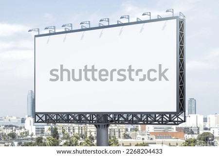 Blank white horizontal billboard on skyline background at daytime, perspective view. Mock up, advertising concept Royalty-Free Stock Photo #2268204433