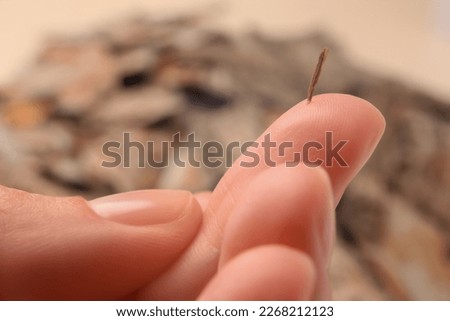 Woman with splinter in her finger on blurred background, closeup Royalty-Free Stock Photo #2268212123