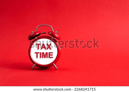 Alarm clock face with text tax time