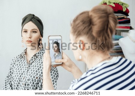 Women fashion designer taking photo to accessories with cell phone or smartphone digital camera for selling online in Internet website or social media