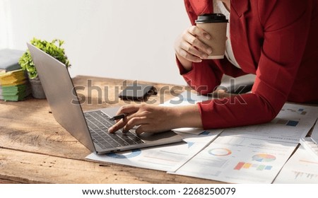 Business woman using laptop for do math finance on wooden desk in office and business working background, tax, accounting, statistics and analytic research concept..