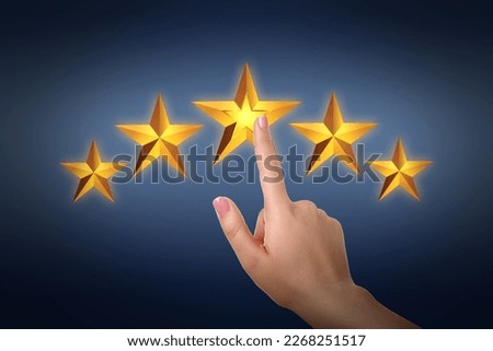 Quality rating. Woman pointing at virtual stars on dark background, closeup