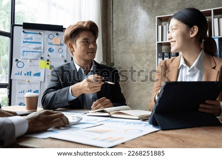 Business people meeting using laptop computer, calculator, stock market chart paper for analysis planning to improve quality next month. Conference discussion corporate concept