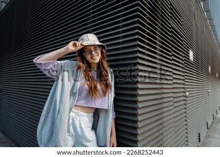 Fashionable funky caucasian girl dancer in sportswear is performing outdoor street dancing motion .  Royalty-Free Stock Photo #2268252443