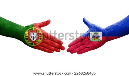 Handshake between Haiti and Portugal flags painted on hands, isolated transparent image.