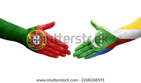 Handshake between Comoros and Portugal flags painted on hands, isolated transparent image.