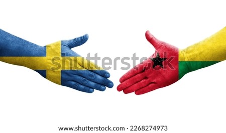 Handshake between Guinea Bissau and Sweden flags painted on hands, isolated transparent image.