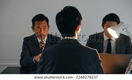 Group of people talking in dark room. Detectives and suspects to interrogate. Criminal drama. Royalty-Free Stock Photo #2268278237