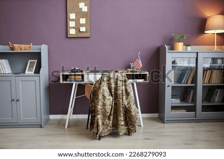 Background image of military uniform at desk chair in office with American flag, copy space