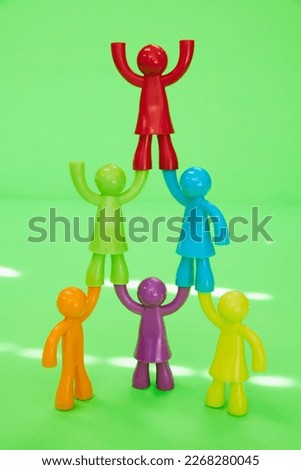 Colorful dolls overlapping on yellow-green background