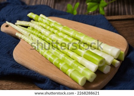 Peeled green bamboo shoots on table Royalty-Free Stock Photo #2268288621