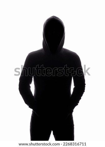 Man in Hood silhouette. Boy in a hooded sweatshirt. Isolate monochrome Photo Royalty-Free Stock Photo #2268316711