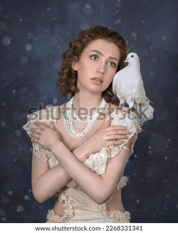 Tender fair-haired girl in a lace bodysuit with a dove on her shoulder