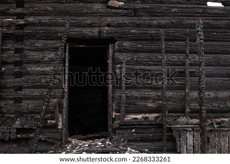 Burned wooden house, black remains of construction