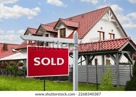 Red Sold sign near beautiful house outdoors
