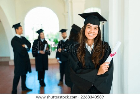 Mexican woman smiling feeling proud and happy about finishing her university education and getting a diploma Royalty-Free Stock Photo #2268340589