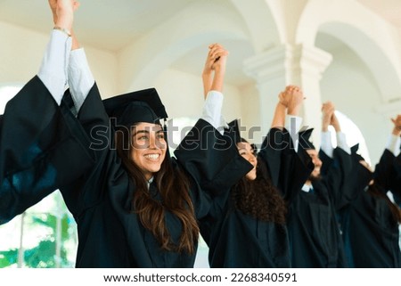 Latin gorgeous woman celebrating with graduates at campus during their graduation ceremony Royalty-Free Stock Photo #2268340591