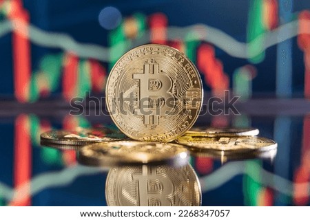 Golden bitcoins on crypto chart with green and red candlesticks background. Cryptocurrency concept