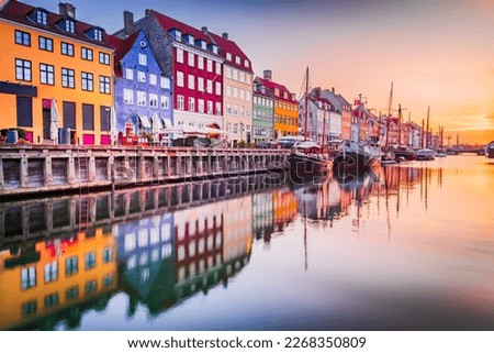 Copenhagen, Denmark. Charm of Nyhavn Canal, iconic place, colorful sunrise, and breathtaking water reflections. Royalty-Free Stock Photo #2268350809