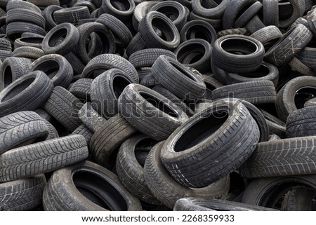 Waste disposal, a stack of end-of-life automobile and truck tires, close up shot. Recycle and environmental conservation concept. Royalty-Free Stock Photo #2268359933