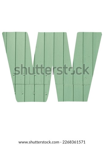 Letter W of the alphabet made with light green wooden boards, isolated on a white background
