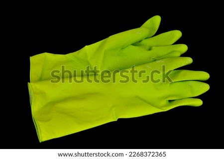 Green rubber gloves for cleaning on Black background and preventing contamination