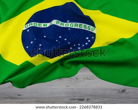 Close up of the official Brazillian Flag with wooden background and copy space