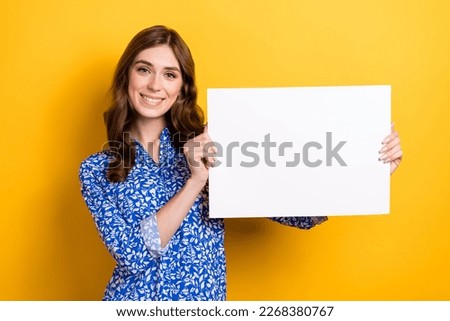Photo of gorgeous stunning lady wear trendy clothes demonstrate paper sheet empty space isolated on yellow color background