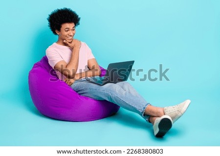 Full body size photo of young guy hair chevelure intelligent student sitting pouf watch minded it development tutor isolated on cyan color background