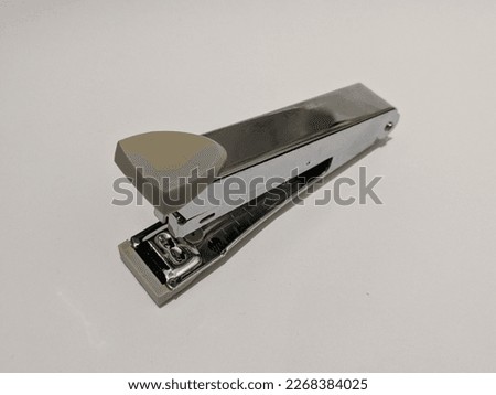 Silver handy stapler isolated on a white background.