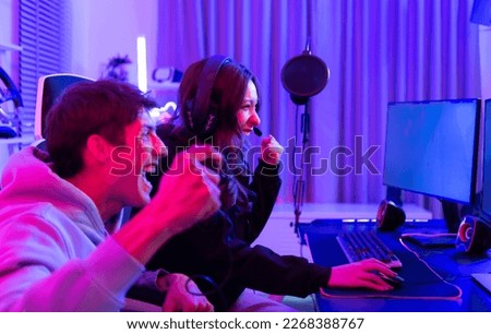 Two professional gamers are in a winning mood. That's the thrill of victory. Royalty-Free Stock Photo #2268388767
