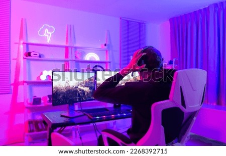 Gamer holding his head with both hands and having a frustrated mood unpleasant when playing a game losing to an opponent