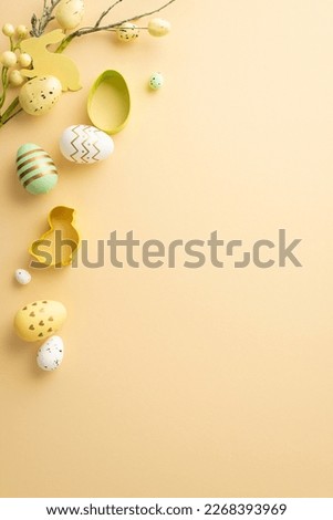 Easter mood concept. Top view vertical photo of colorful easter eggs baking molds and easter plant on isolated pastel beige background with copyspace