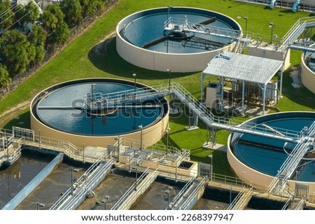 Aerial view of modern water cleaning facility at urban wastewater treatment plant. Purification process of removing undesirable chemicals, suspended solids and gases from contaminated liquid Royalty-Free Stock Photo #2268397947