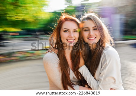 girls friends laughing and outdoor on the carousel Royalty-Free Stock Photo #226840819