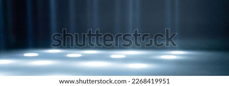 blurred rays of light on the disco floor. white blue neon searchlight lights. laser lines and lighting effect. night empty stage in studio with neon reflections. scene dark abstract background. banner Royalty-Free Stock Photo #2268419951