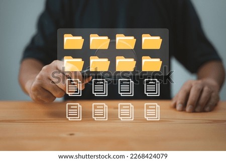 Yellow folders, documents, media content displayed on monitor. Office clerks search, index files. File manager, data storage, search.