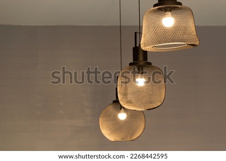 Warm light bulbs in vintage coffee cafe or coffee shop, show idea design and concept with copy space. Royalty-Free Stock Photo #2268442595