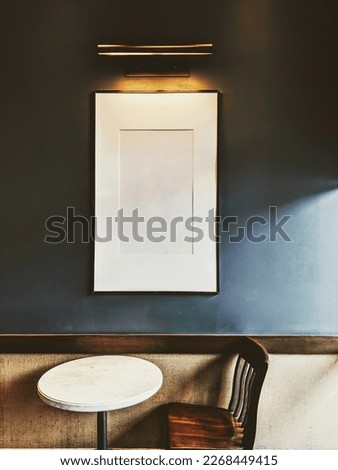 a frame on a table and chairs