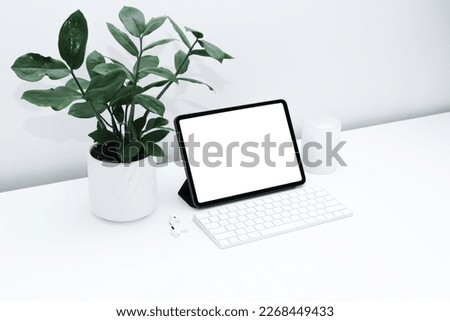 a tablet with a blank white screen and keyboard