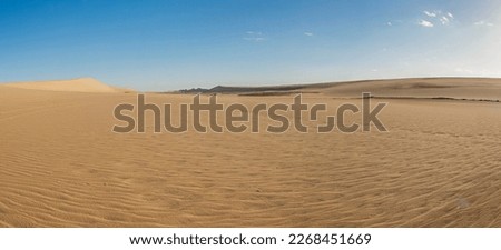 Landscape scenic view of desolate barren western desert karaween sand dunes in Egypt with blue sky background Royalty-Free Stock Photo #2268451669