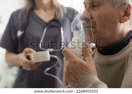 Asthma COPD Breath Nebulizer And Mask Given By Doctor Or Nurse. Royalty-Free Stock Photo #2268453353