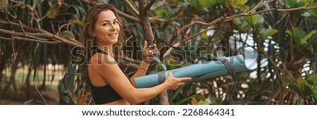 Attractive young woman in black sport brapreparing for yoga exercises in nature, in park. Outdoor activities. Healthcare health active life concept. Banner