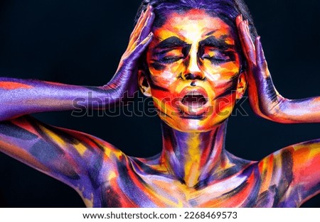 Woman in color body painting on her face. Cover art for your mixtape, video, song or podcast. Bodyart design for book covers.