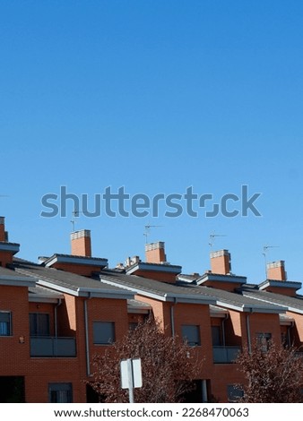 Rooftops of houses in suburban district Ensanche de Vallecas in Madrid, Spain. Vertical photo. Backdrop.