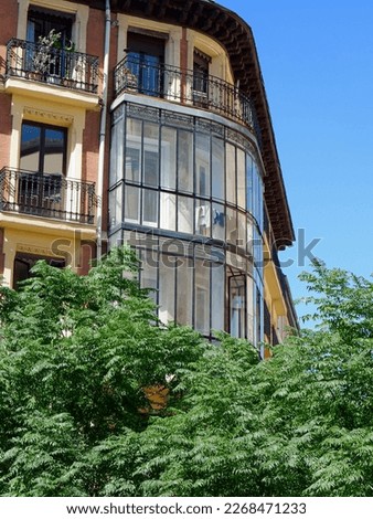 Rounded corner of old classical building in Anton Martin neighbourhood, centre of Madrid, Spain. Vertical photo.