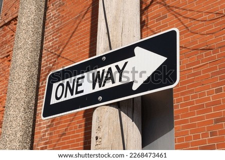 One Way sign in back alley.