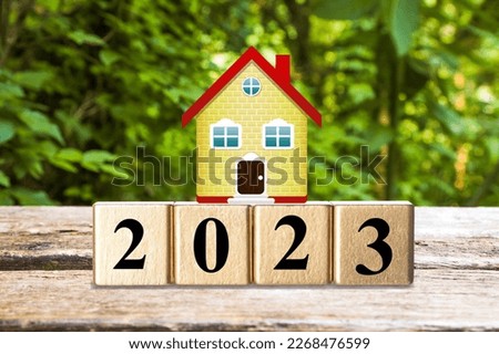 Property concept. House model and cubes with number 2023
