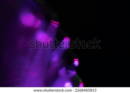 Blur neon light. Lens flare overlay. Bokeh fluorescent flash gleam. Defocused blue purple color flecks on dark black abstract background. Royalty-Free Stock Photo #2268485813